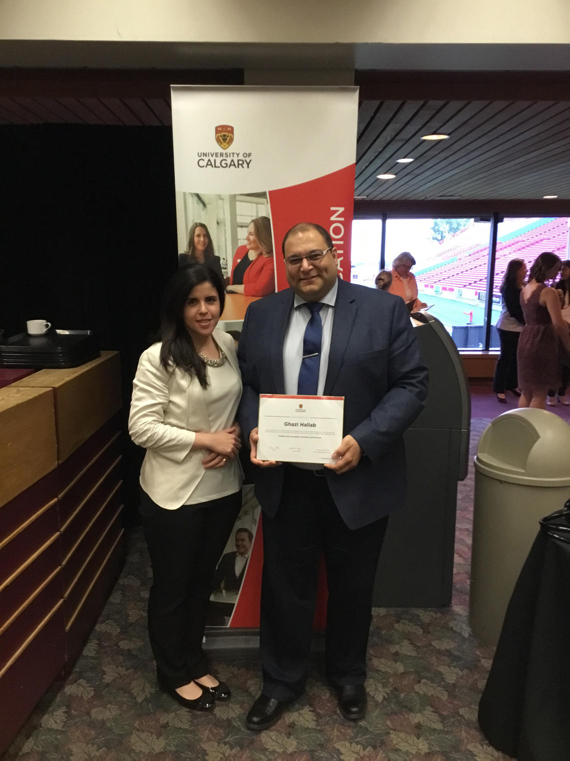 Ghazi Hallab and his wife, Lina, pose with his Continuing Education certificate in career and academic advising.