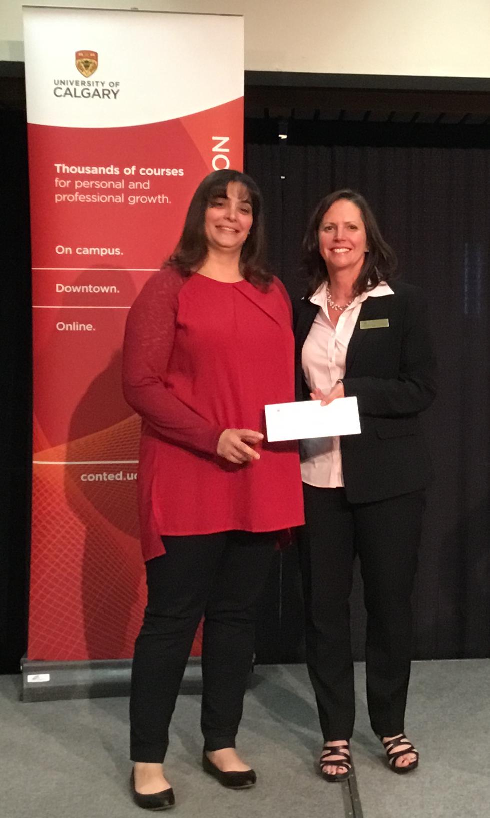 Mona Amery, left, receives the Continuing Education Lifelong Learning Award from Sheila LeBlanc, director of Continuing Education.