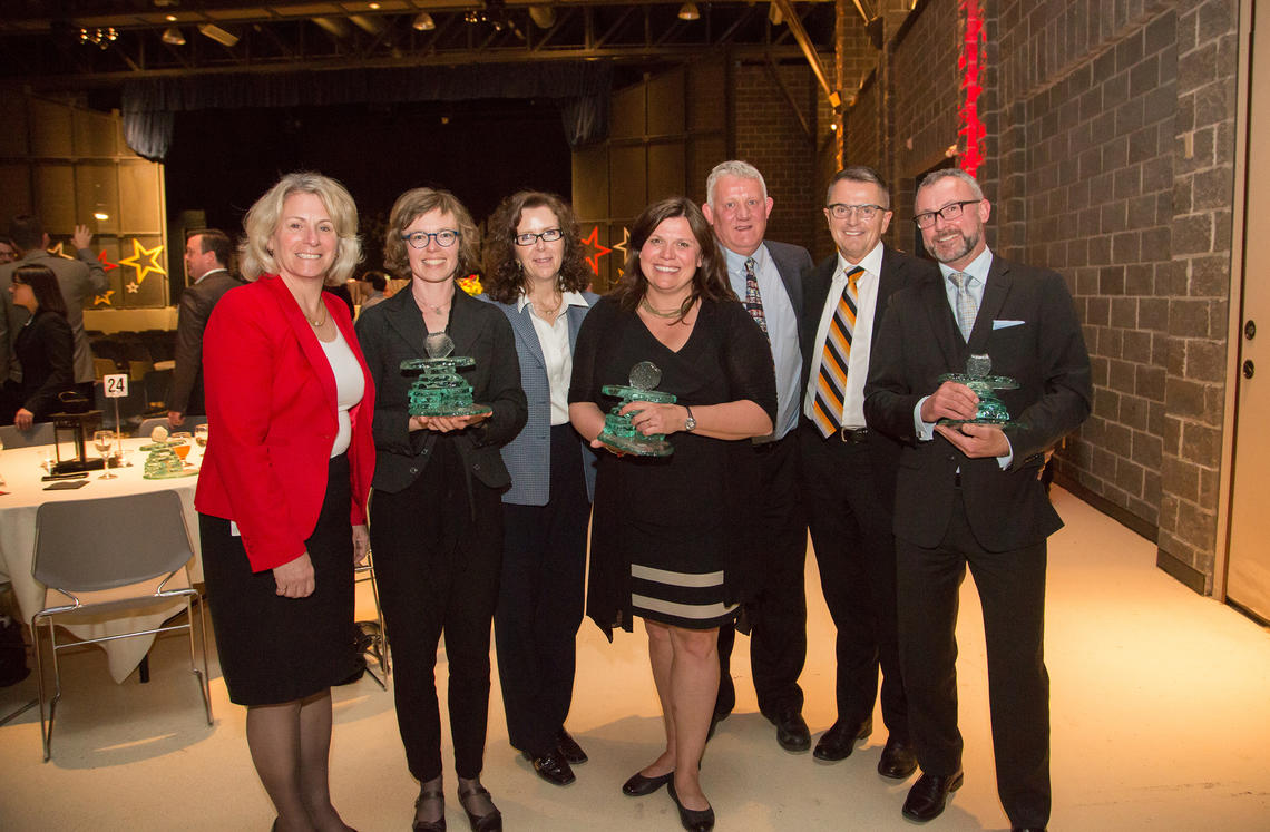 President Elizabeth Cannon congratulates 2015 U Make a Difference recipients (holding their Inukshuks), from left: Kinga Olszewska, Dianne Gereluk and Jim Baker, who celebrate along with Werklund colleagues Brenda McDougall, Gavin Peat, and Dean Dennis Sumara.