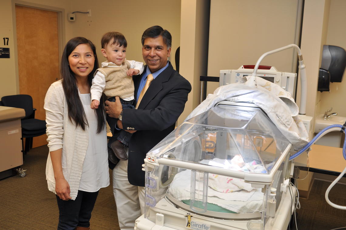 Aileen Soare, left, with her young son, Jonah (who was born prematurely in 2013) and Dr. Abhay Lodha, an assistant professor in the Department of Paediatrics at the Cumming School of Medicine and a member of the university’s Alberta Children’s Hospital Research Institute.