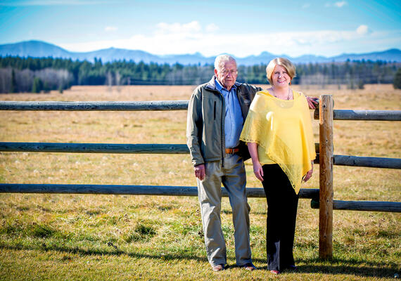 Two people stand on a farm