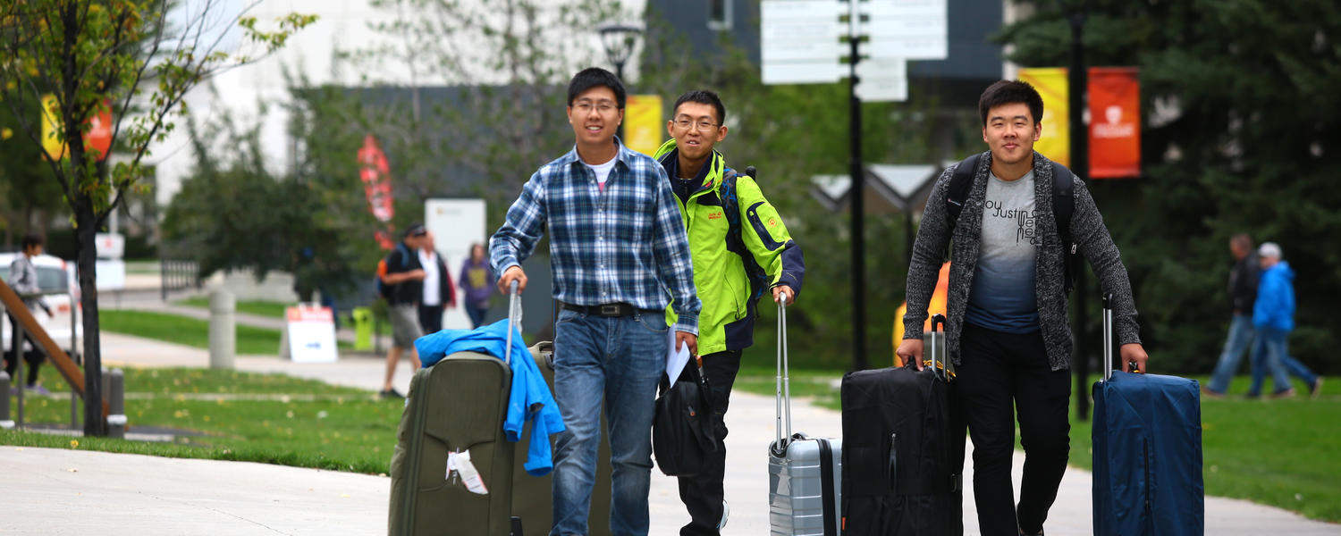three students moving out.