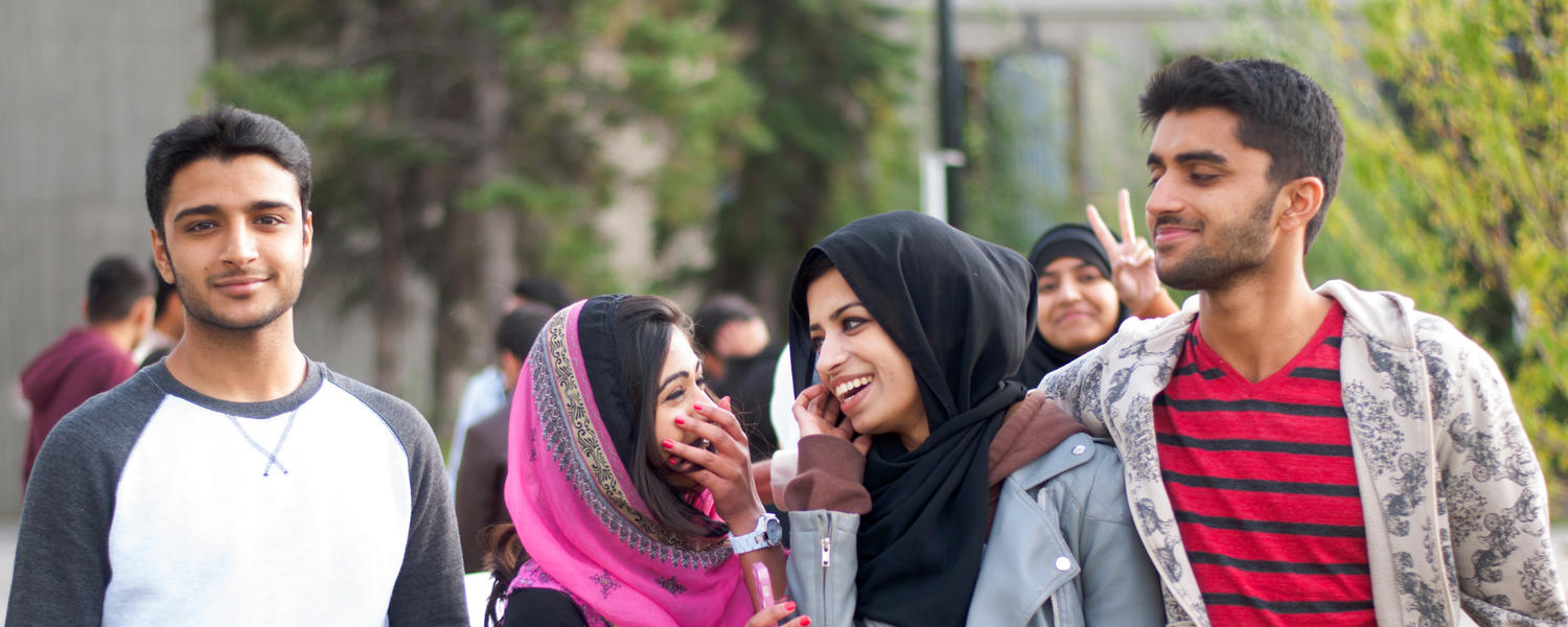 four students walking on campus.