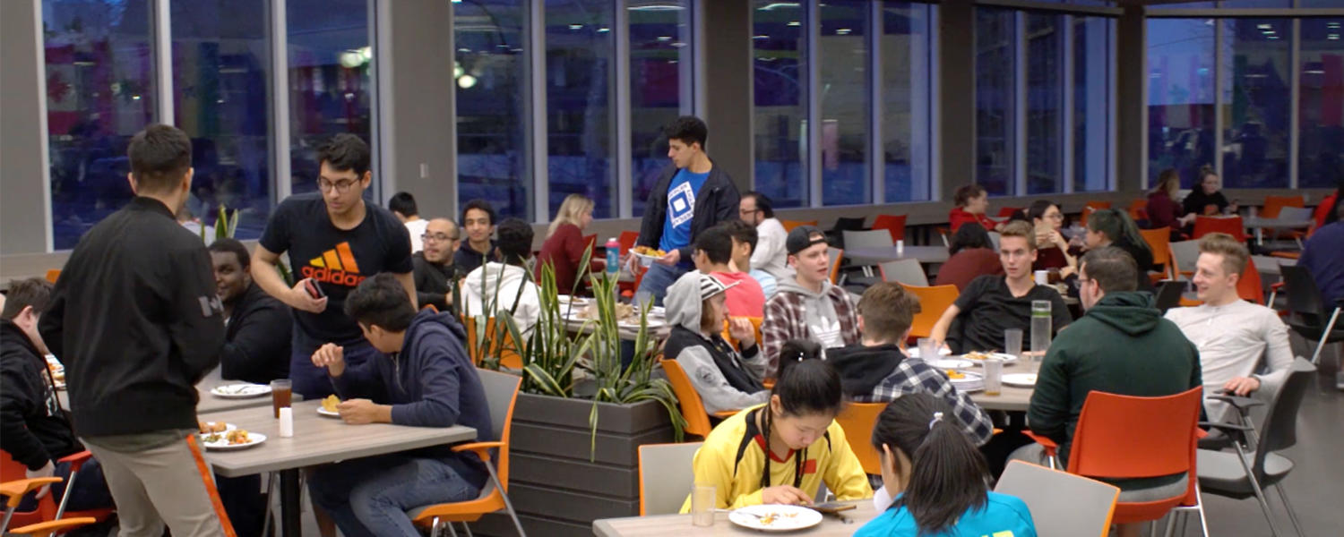 Students at the University of Calgary eating and socializing at The Landing in the Dining Centre