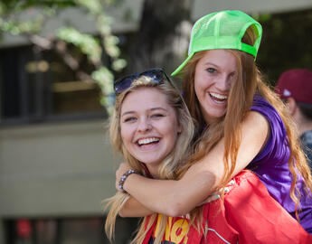 two UCalgary students in front of residence.