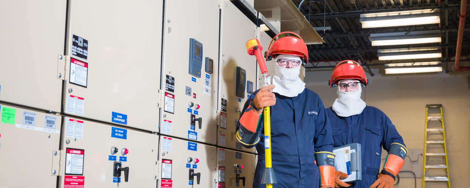 Two workers in Personal Protective Equipment