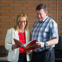 Two people reading a book