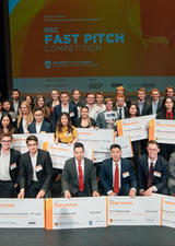Students on stage with prizes