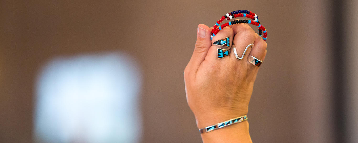 Consultation - hand holding beads (ii’ taa’poh’to’p Indigenous UCalgary)