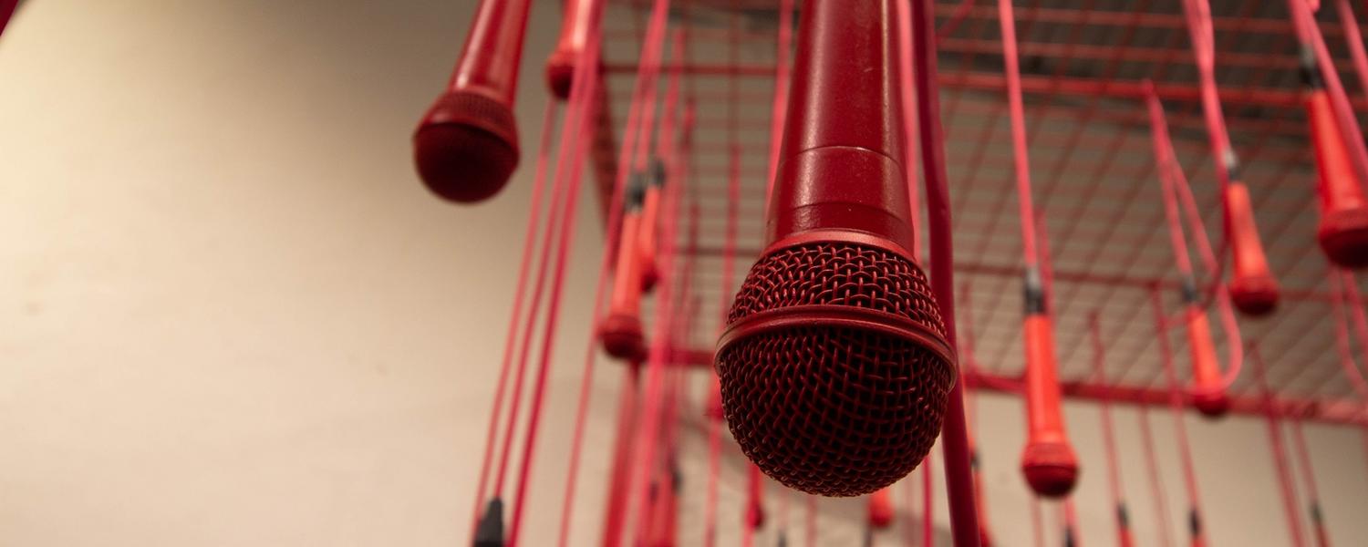 red microphones hang from the ceiling.