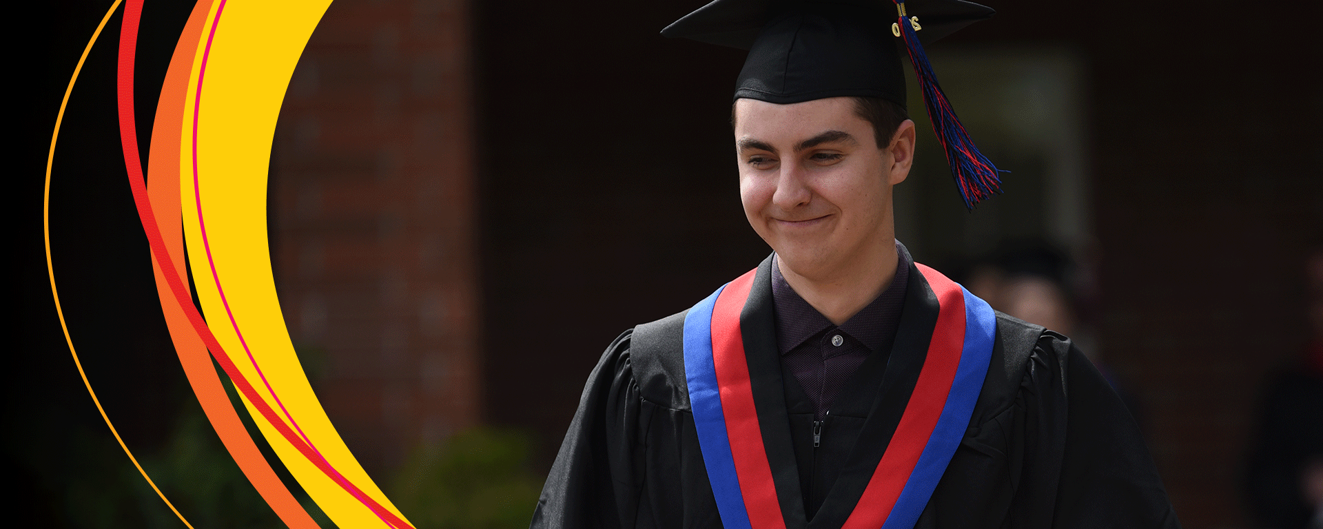 Young man at graduation, wearing a cap and gown