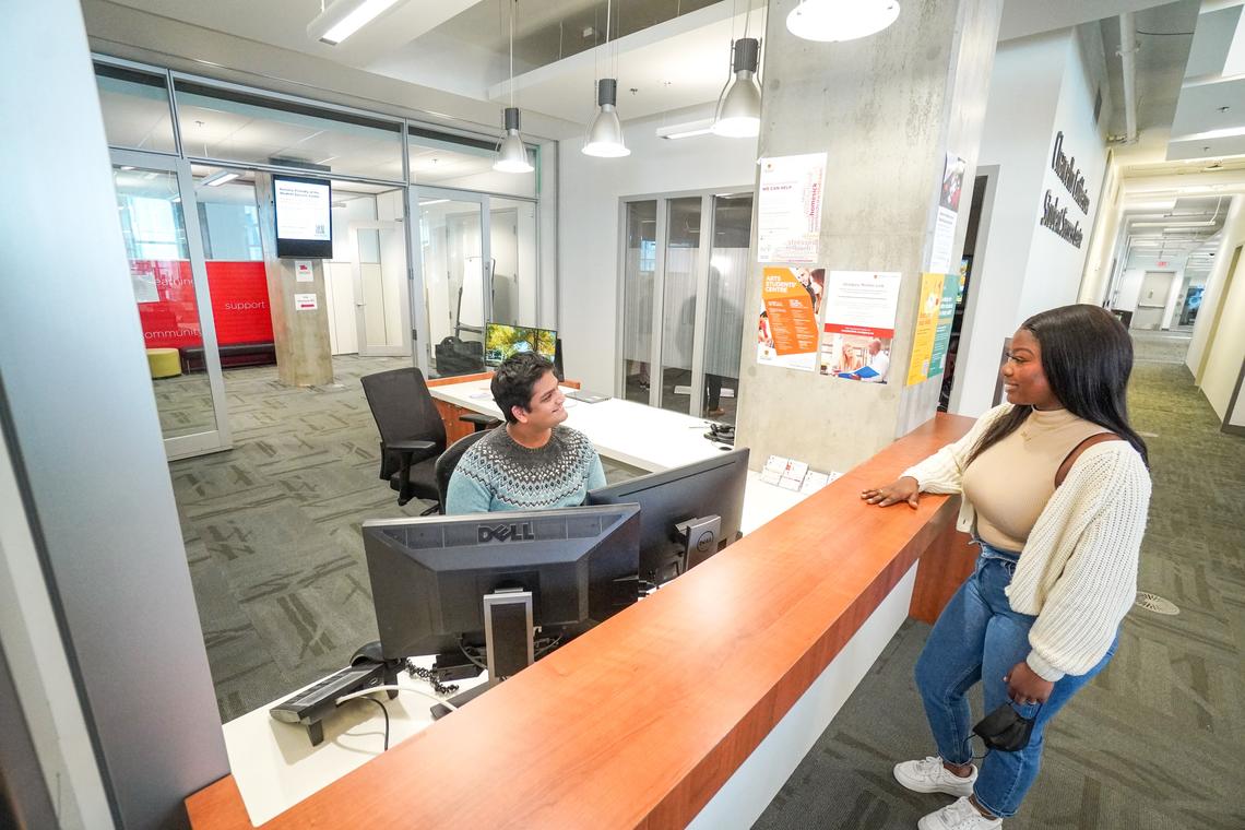 A student checks in at the front desk of the Student Success Centre.