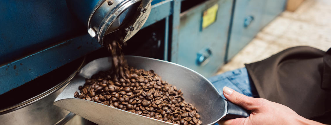 Fair Trade coffee beans being poured from storage