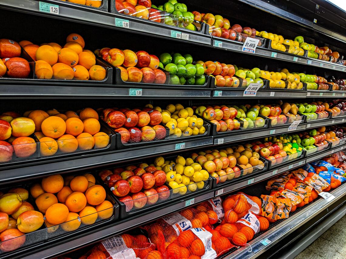 A photo of fruit on shelves 