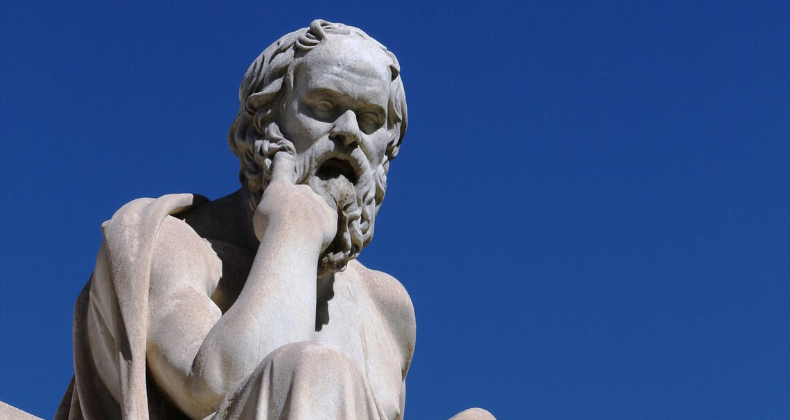 Statue of Socrates with a blue sky in the background