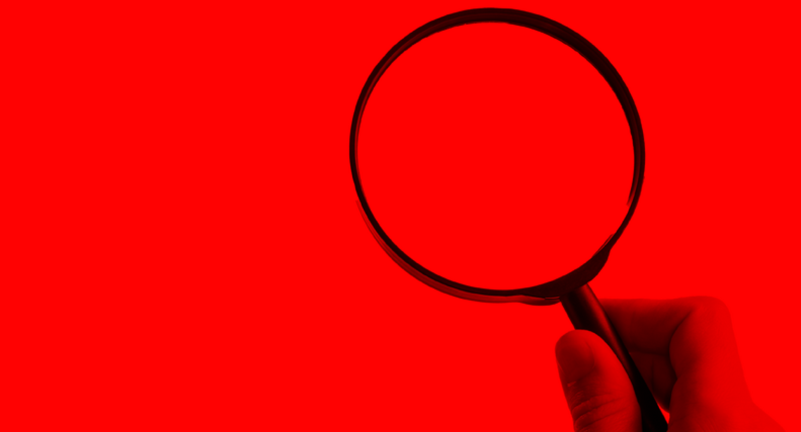 Decorative image of magnifying glass on red background.