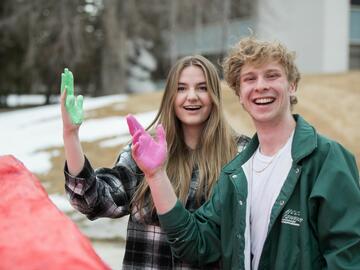 Students painting The Rock, a symbol of free expression for students on UCalgary’s campus.