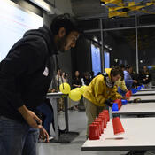 A student plays a cup game.