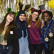 Students pose in a festive photo booth. 