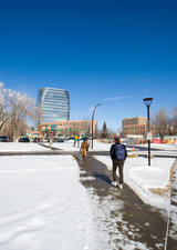 student walking on main campus during winter