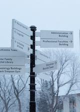signage on a snowy main UCalgary campus