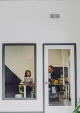 two people sitting in an office