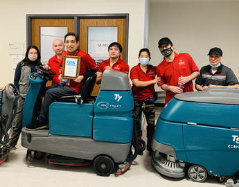Caretakers stand by cleaning machines