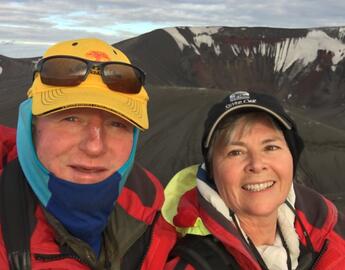 selfie of a man and woman on a mountain