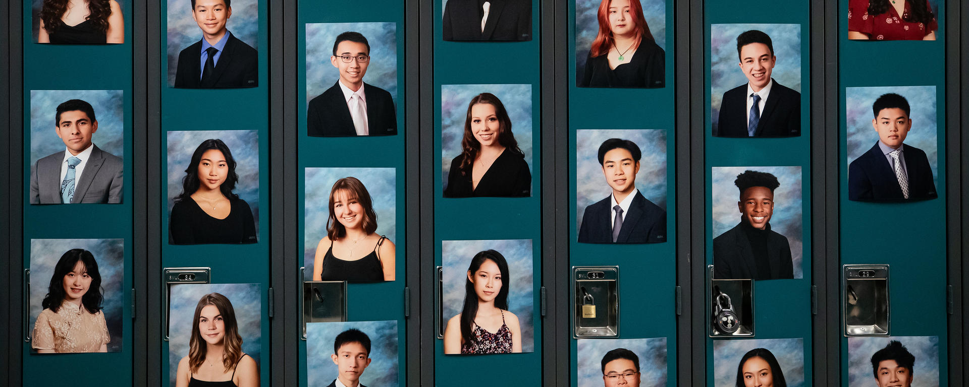Photos of graduating students are seen on lockers during a graduation ceremony.