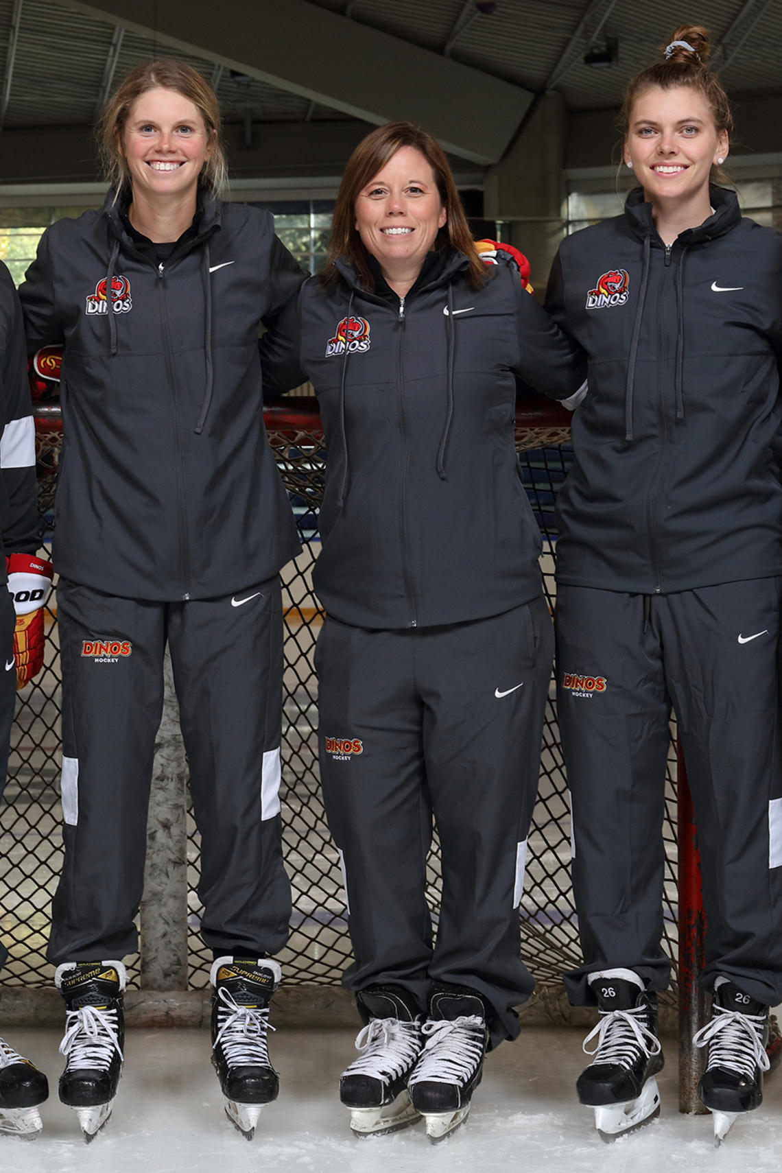 Carla MacLeod, Dinos head coach of hockey, centre, with members of her team. 