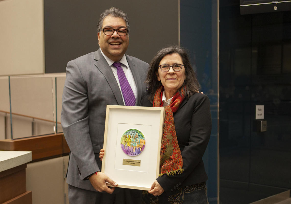 Calgary Mayor Naheed Nenshi  presents the award to the University of Calgary's Susan Barker. Photo courtesy City of Calgary