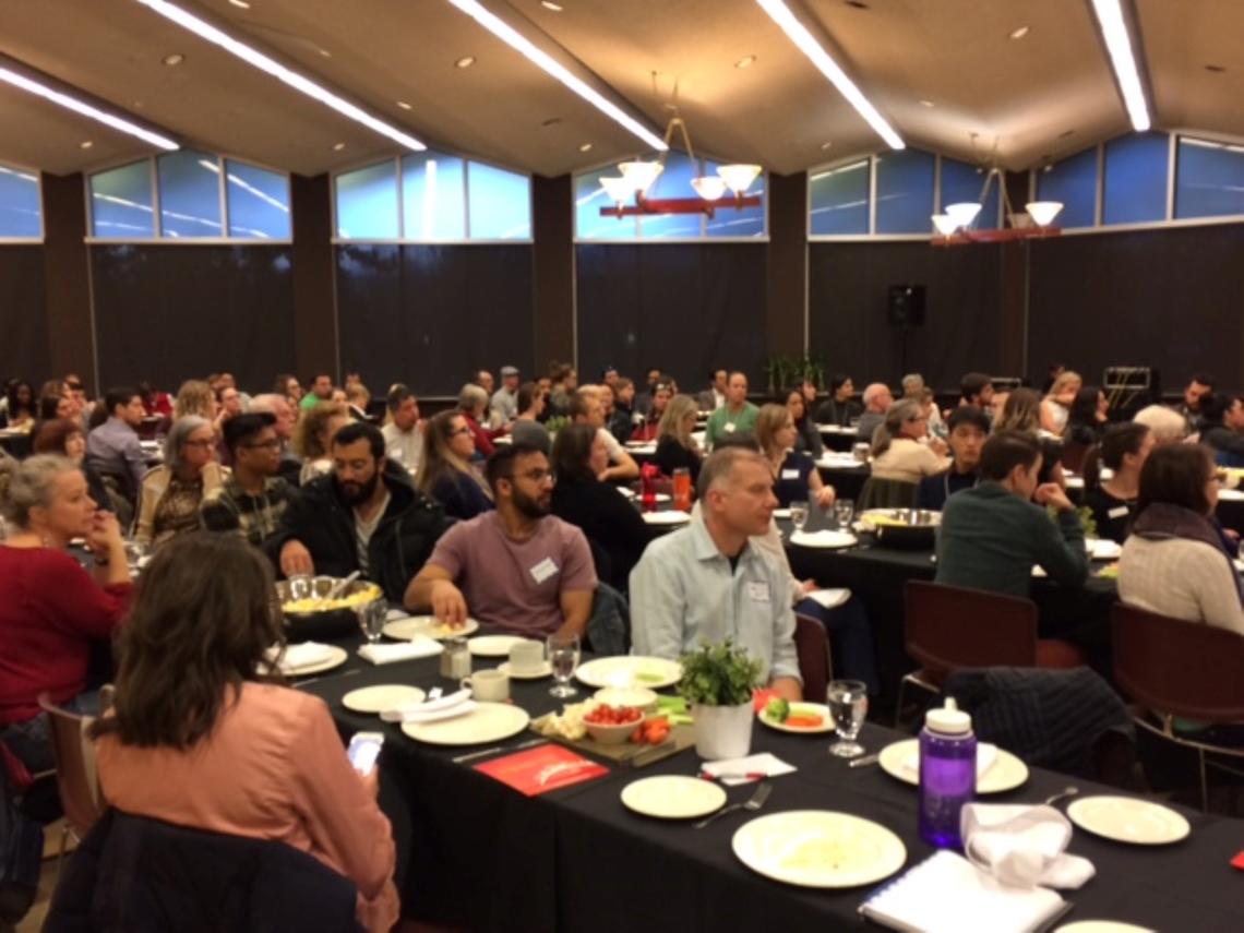 Ahead of dinner, event attendees listen to a presentation on food trends and innovations. University of Calgary photo