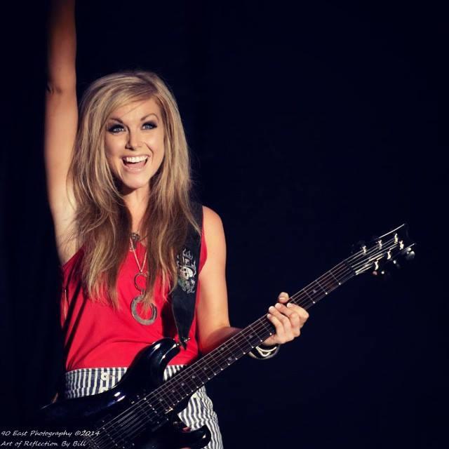 With an expression of pure joy on her face, Lindsay Ell waves to the audience during one of her performances.