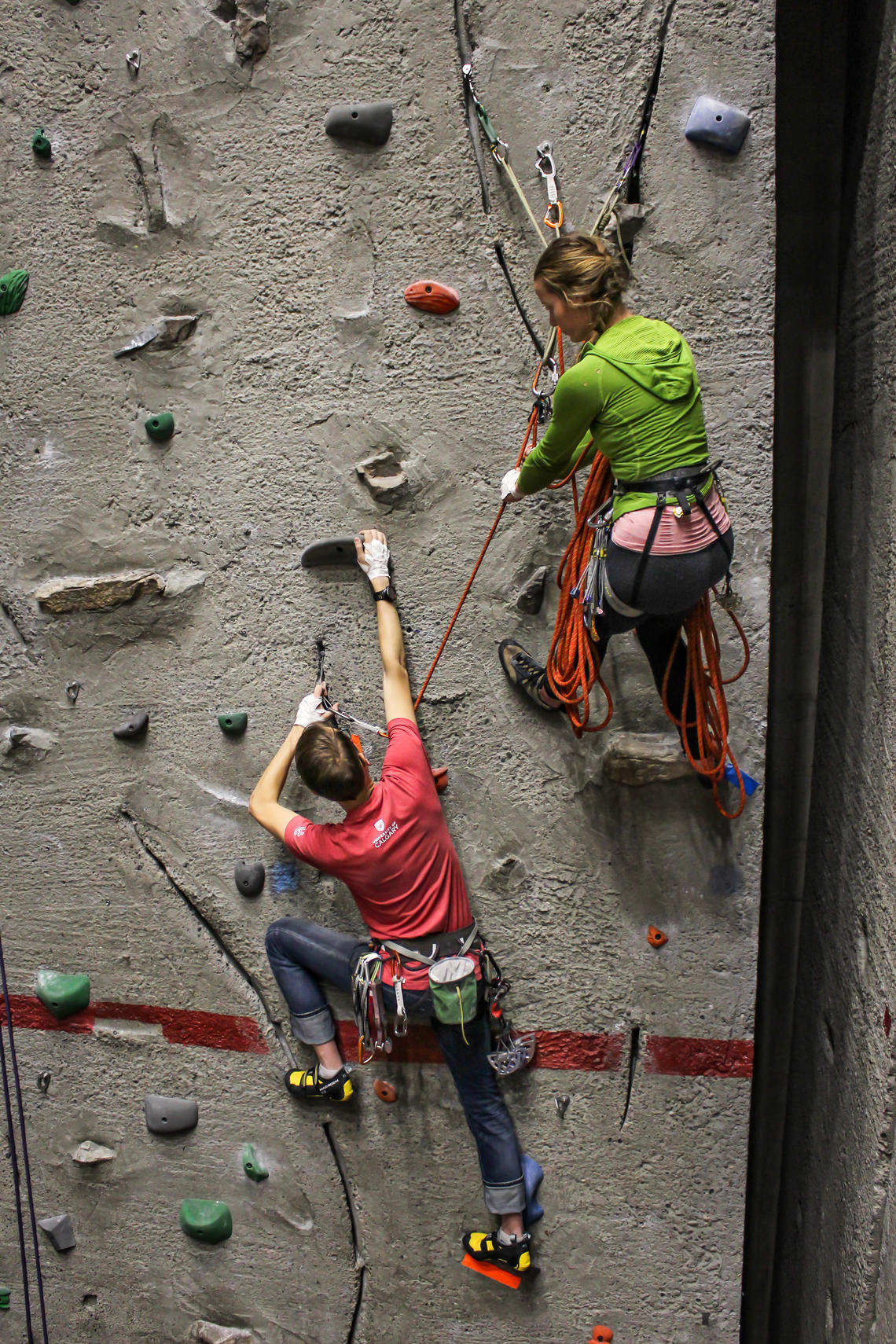 Ashley Weeks and climbing instructor Pieter van Staalduinen work the climbing wall. 