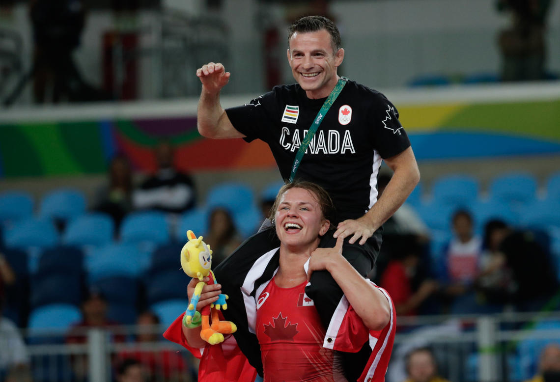 Erica Wiebe carries her coach Paul Ragusa after winning wrestling gold at Rio 2016.