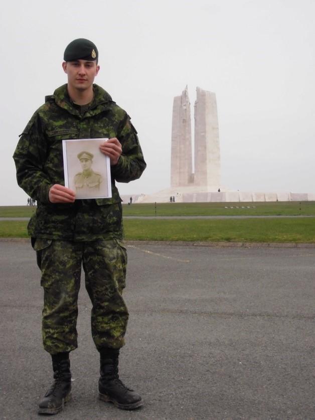 Ryan Shudra, now a University of Calgary student in the Faculty of Law, stands near the Canadian National Vimy Memorial in France, holding a photo of his great-grandfather, who fought in the Battle of Vimy Ridge.Ryan Shudra