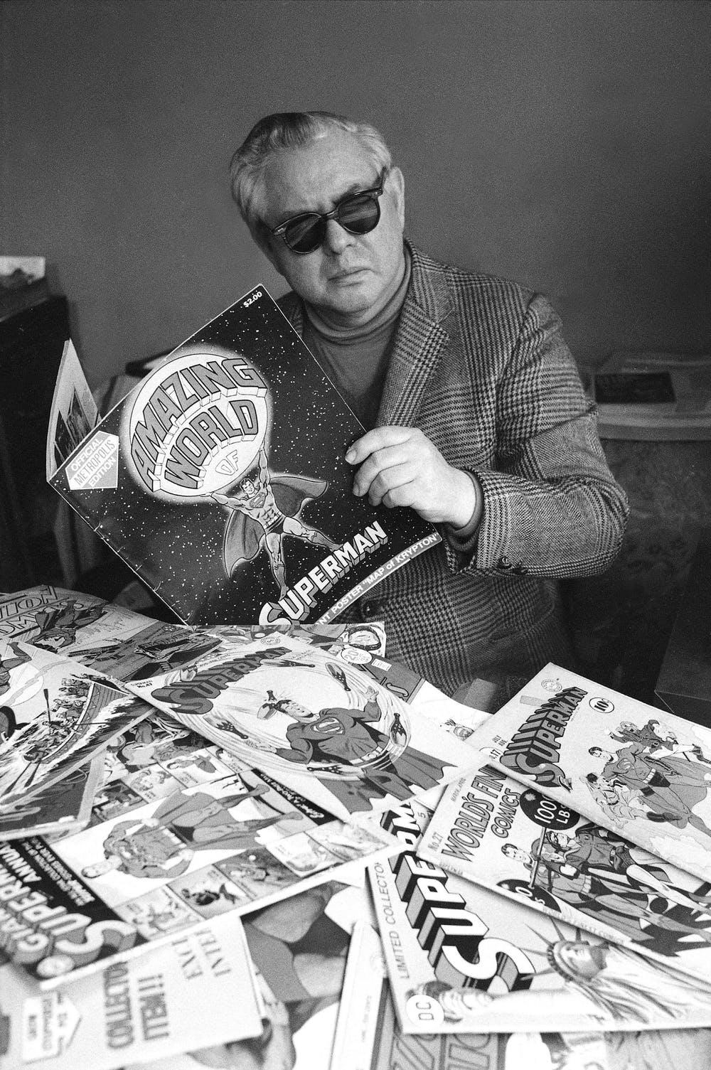Joe Shuster with Superman comic books