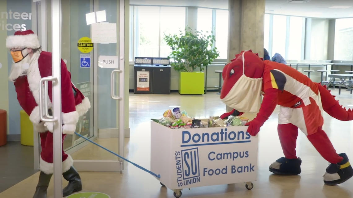Santa and Rex making donations to the SU