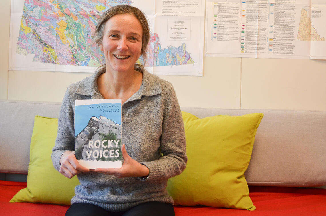 Eva Enkelmann displays her book Rocky Voices: The Memories of Minerals That Form the Rocky Mountains in her office.