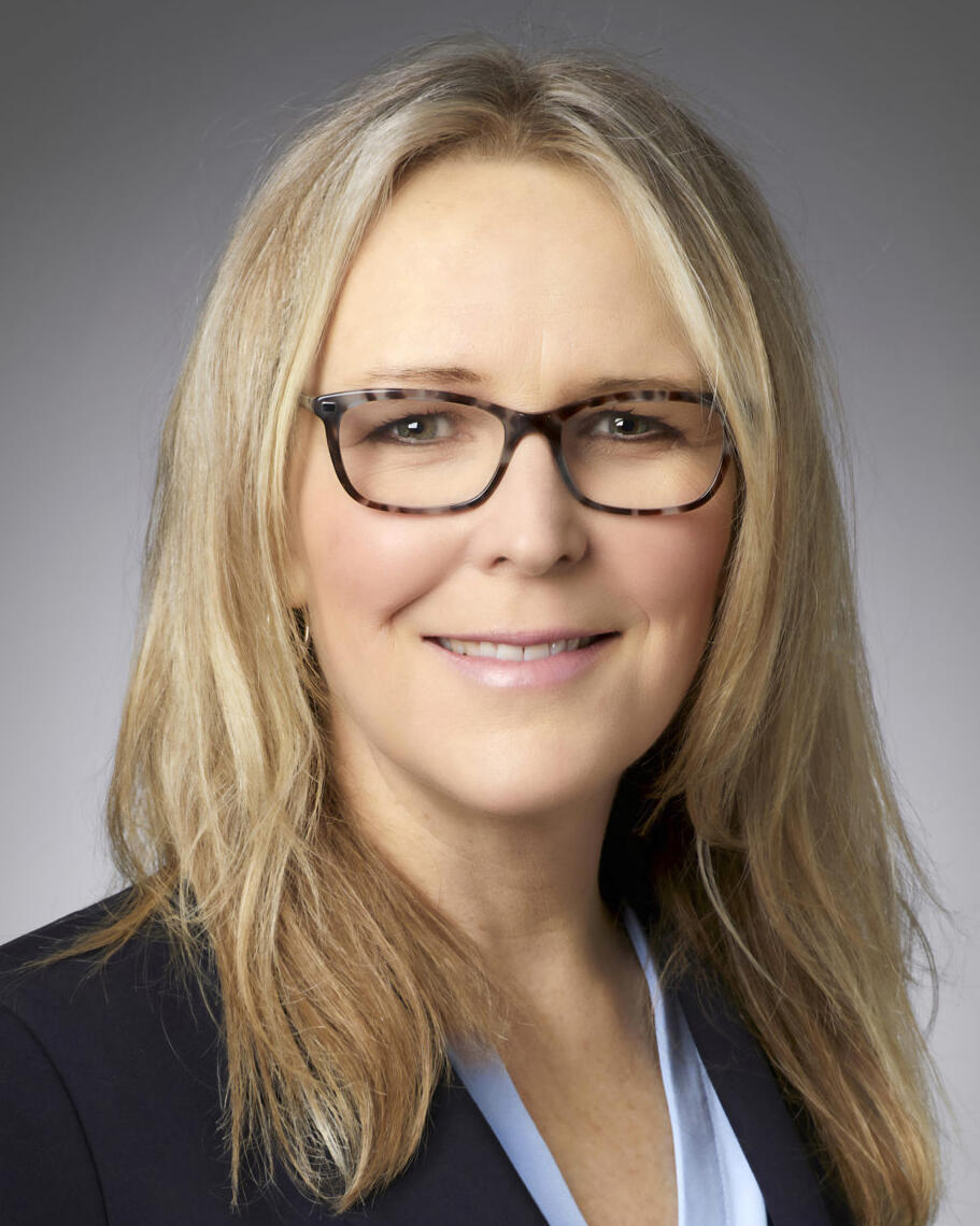 A woman with blonde hair and glasses