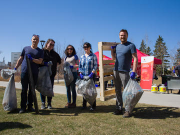 The University Relations team weighing in litter collected as part of the ninth annual Campus Cleanup and Barbecue on April 27