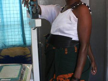 An expecting mother is weighed at a routine prenatal check up at a health dispensary in Kwimba District, Tanzania.