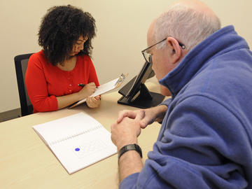 Study participants undergo a series of evaluations throughout the course of the study to monitor any changes in mood, memory and thinking. Here, psychometrist Mekale Kibreab conducts the assessment with Meier.