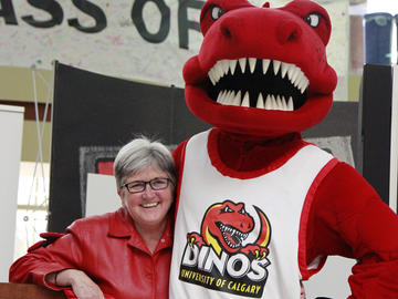 Dr. Dru Marshall helps unveil the refreshed look for the Dinos in 2013.