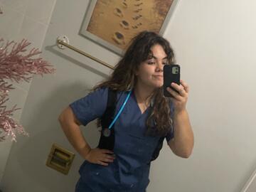 Kristi-Anne takes a mirror selfie wearing her scrubs