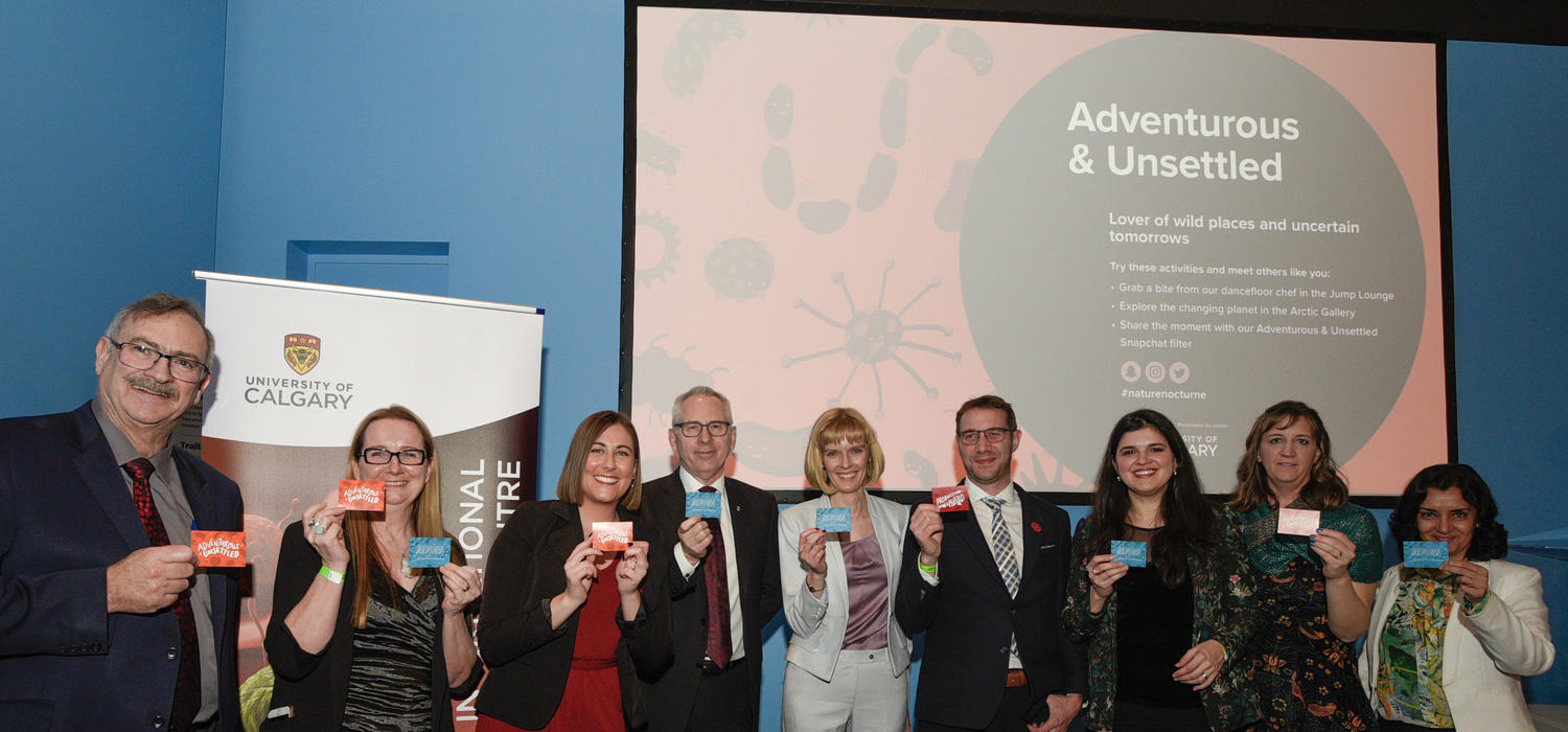 UCalgary faculty and staff hold up their microbiome personality cards. 