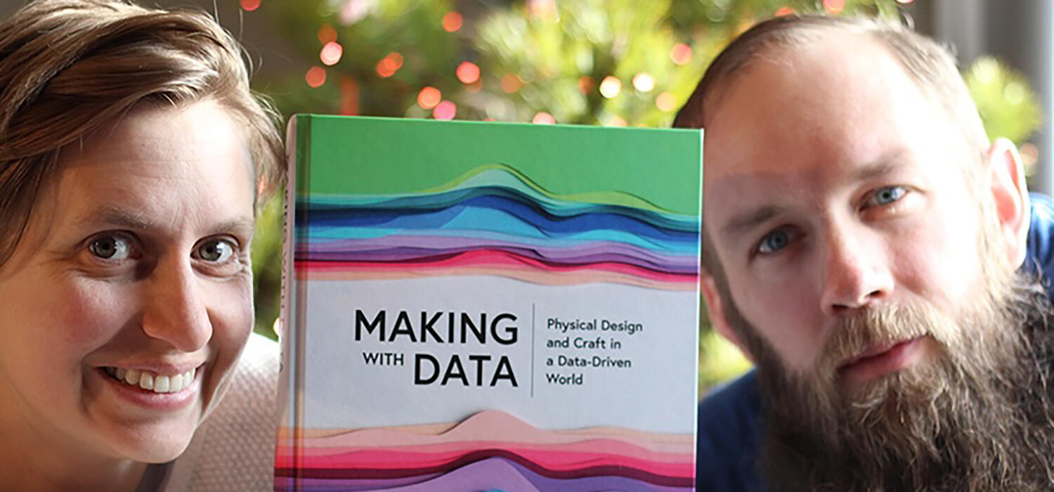 Lora Oehlberg and Wesley Willett pose with their book, Making with Data: Physical Design and Craft in a Data-Driven World.