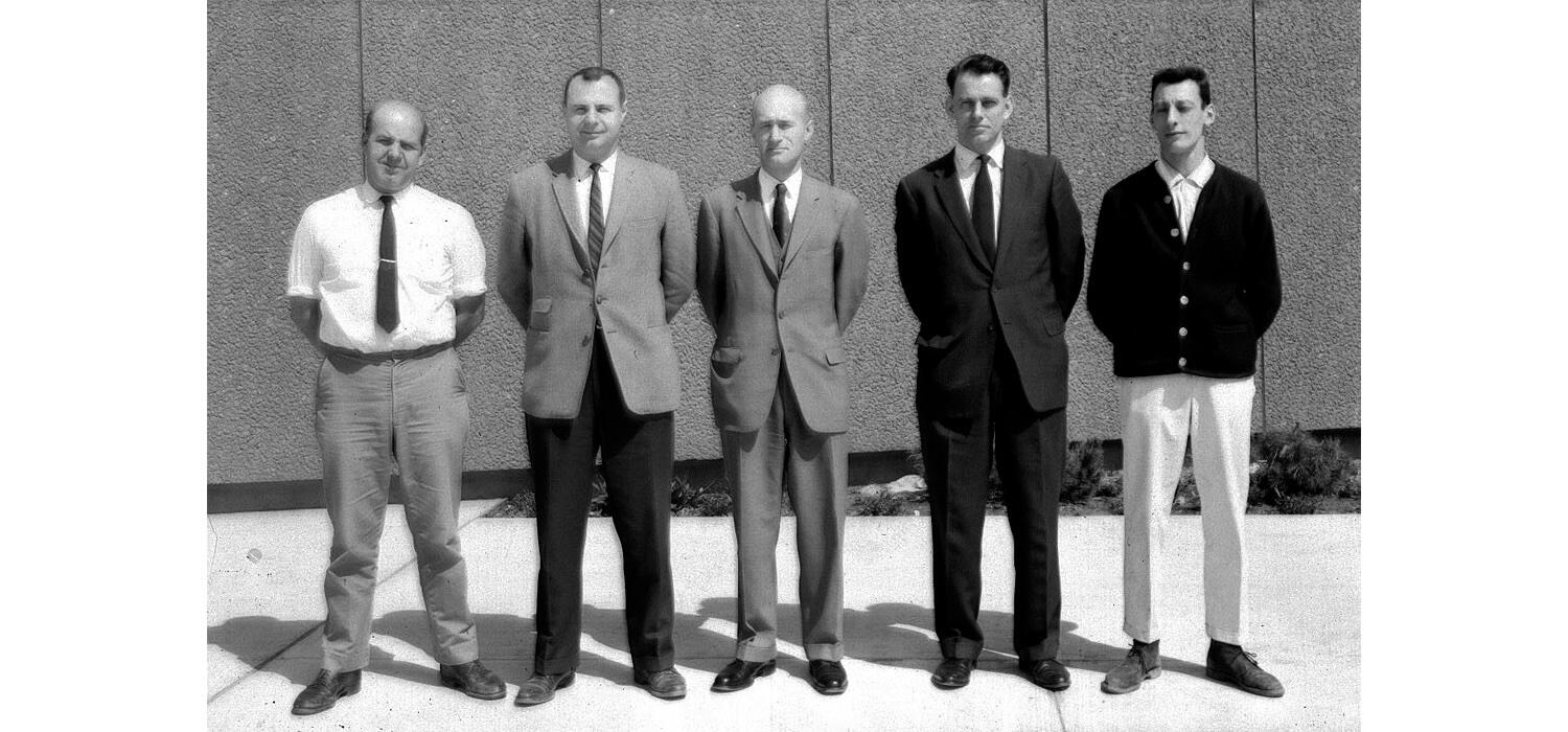 A black and white photo of men in the 1950s