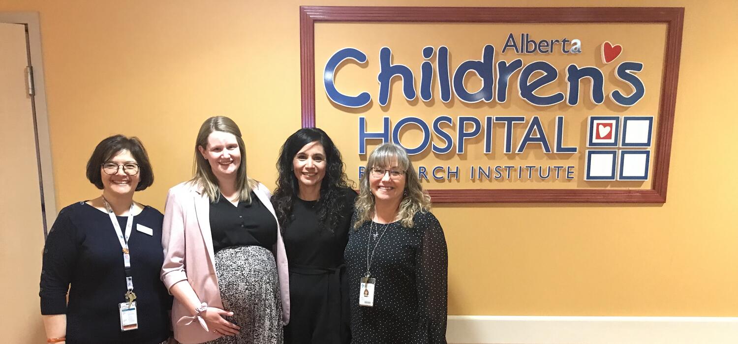 A group of people stand in front of a children's hospital sign