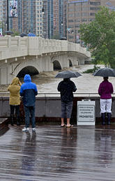 Calgarians watch the waters rise in the Bow River during the June 2013 flood. Social media played a critical role in keeping citizens informed during the disaster.